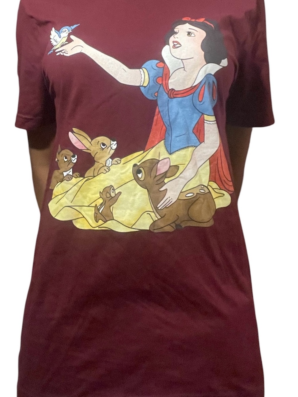 burgundy t-shirt features a graphic print of Disney's Snow White forest animals